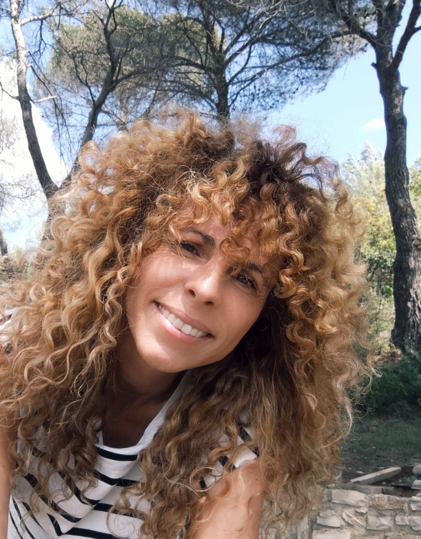 Founder smiling outdoors in the Luberon